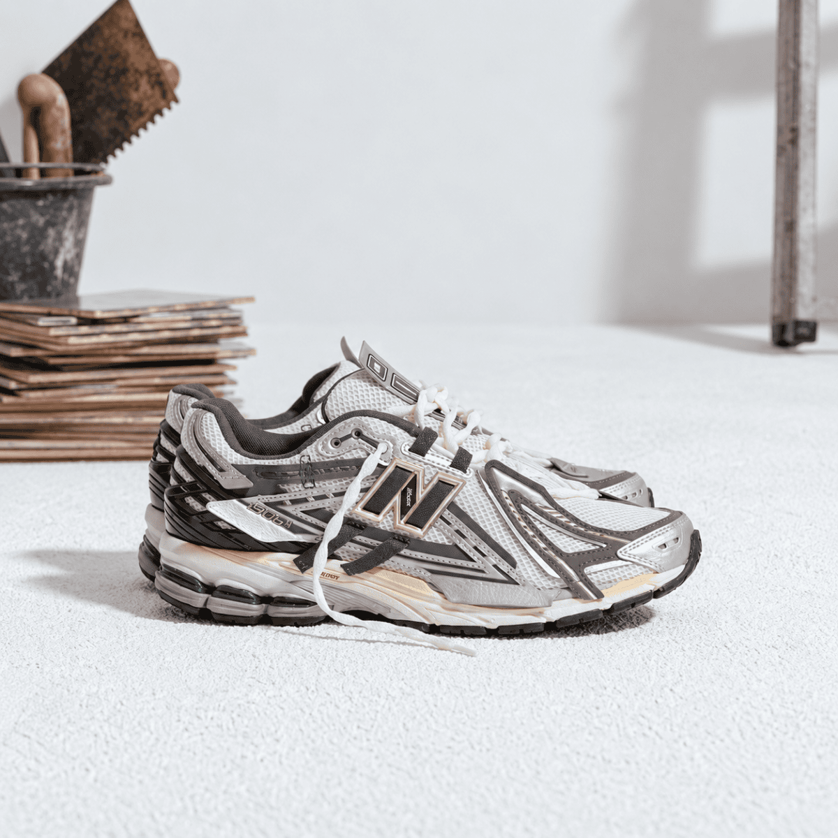 New Balance 1906 Mesh-Panel Sneakers in grey and white on a white surface.