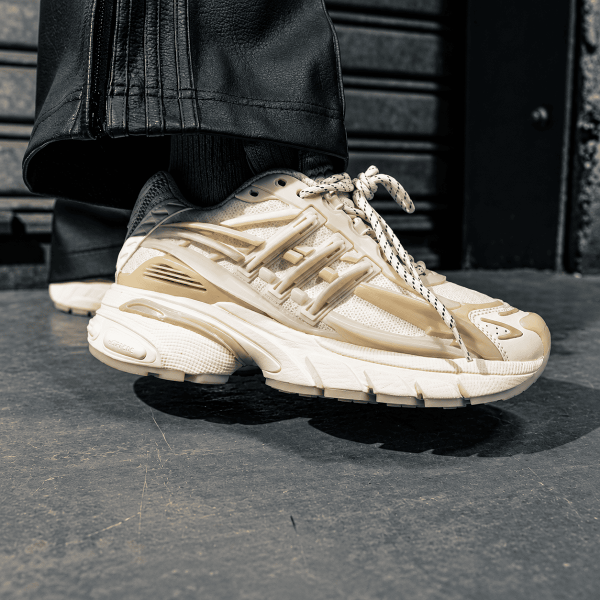 Adidas Adistar Jellyfish sneakers in Chalk White on black surface.