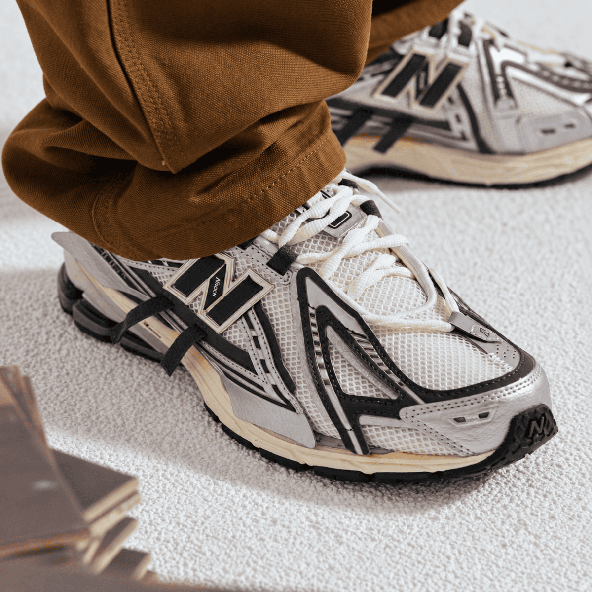 Person wearing New Balance 1906 Mesh-Panel Sneakers in white and black.