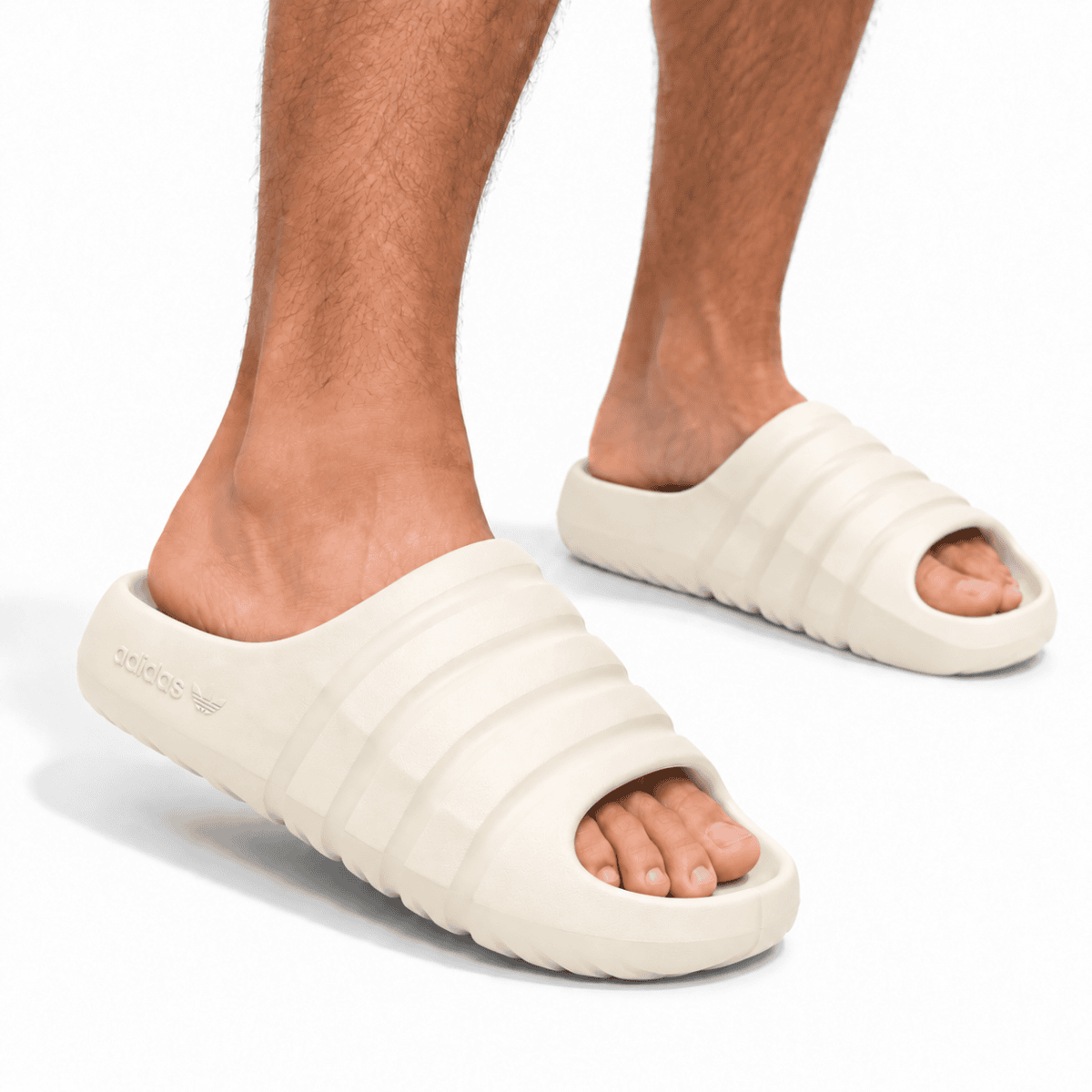 Adidas Adilette Ayoon Slides x Bad Bunny in cream color on feet.