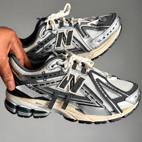 New Balance 1906 Mesh-Panel Sneakers in beige, black, and gray with white laces.