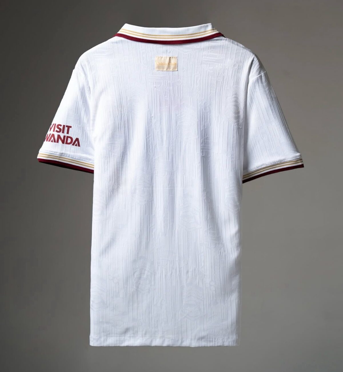 White football jersey with red and gold accents, back view, Visit Rwanda logo on sleeve.
