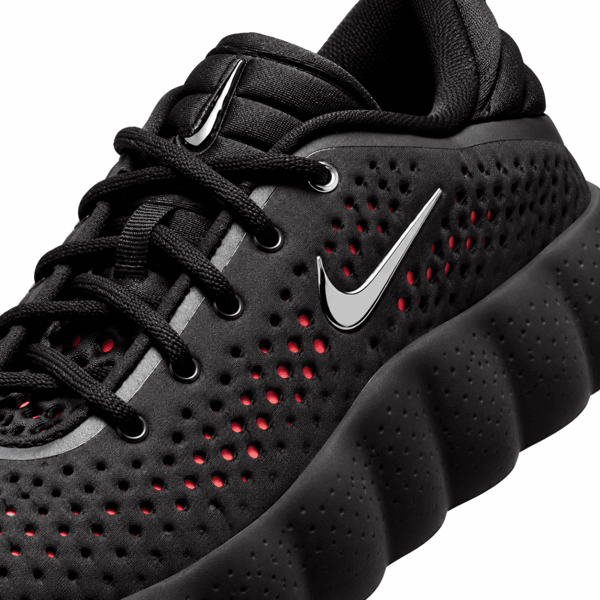 Nike Mind 002 black and hyper crimson athletic shoe with perforated upper and Nike swoosh.