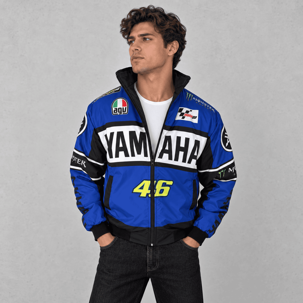 Man wearing a Yamaha racing team jacket with Yamaha logo and racing patches.
