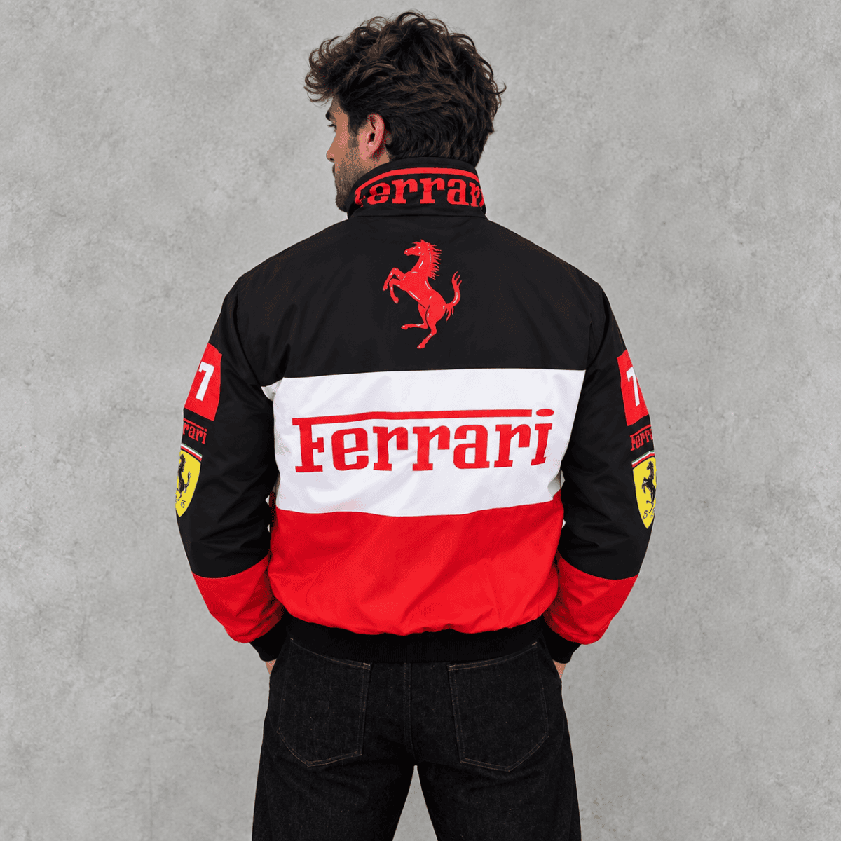 Black, red, and white Ferrari racing jacket with logo and sponsor patches.