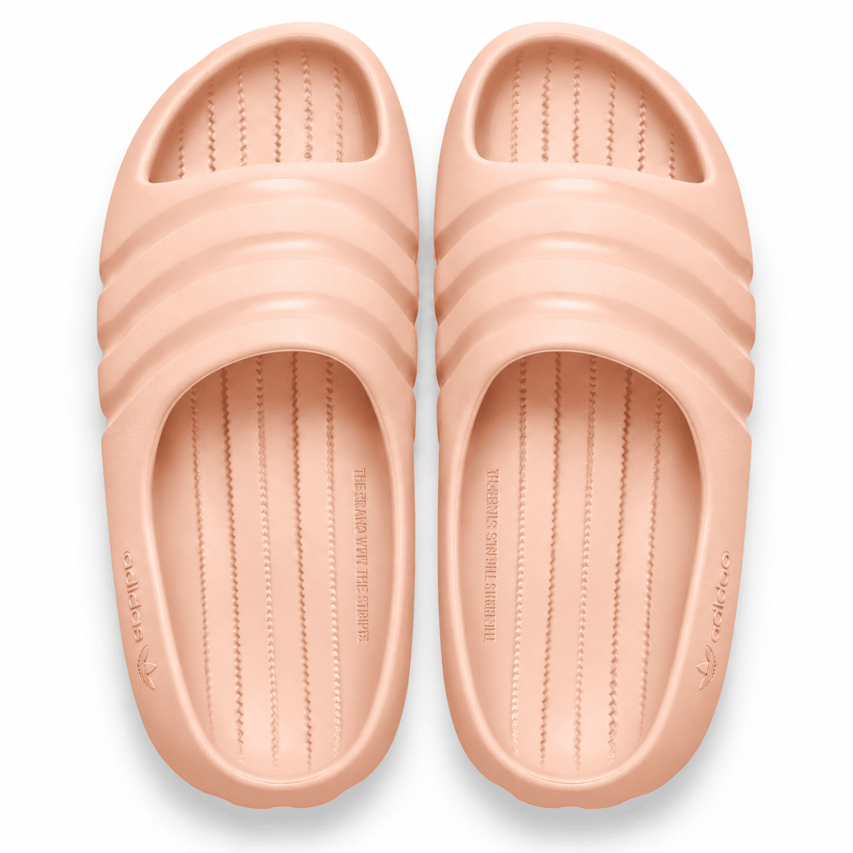 Light peach Adidas Adilette Ayoon slides with textured footbed and wide straps.