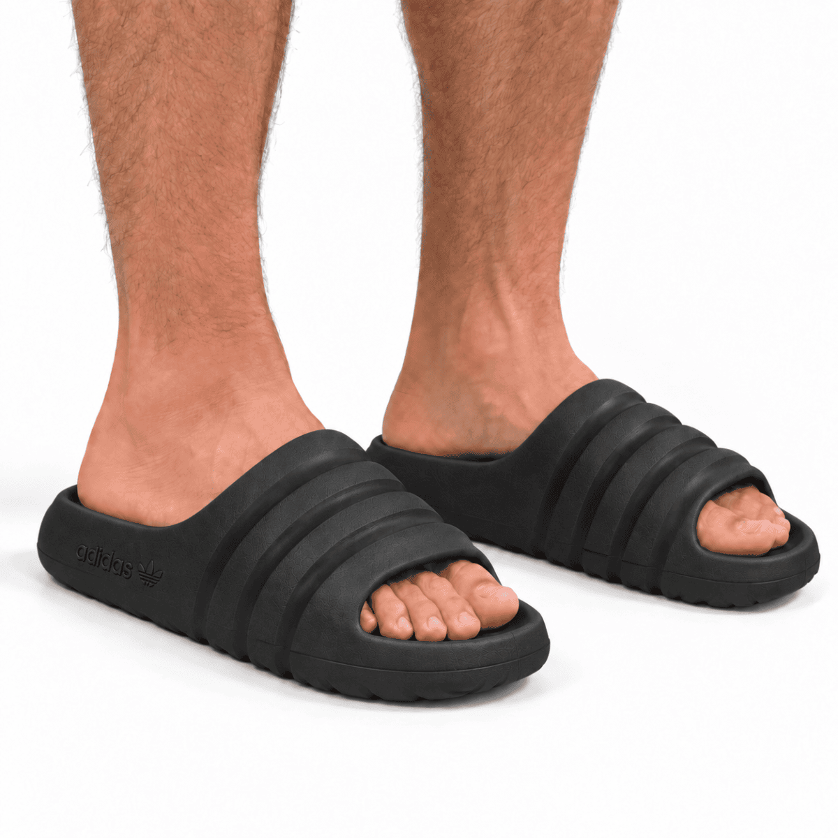Black adidas Adilette Ayoon Slides x Bad Bunny on person's feet.