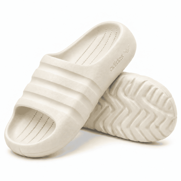 86497b95-3559-4080-8bd5-09d07b4d3a99 - UAE SPORT STORE Cream Adidas Adilette Ayoon Slides with Bad Bunny logo on the sole.