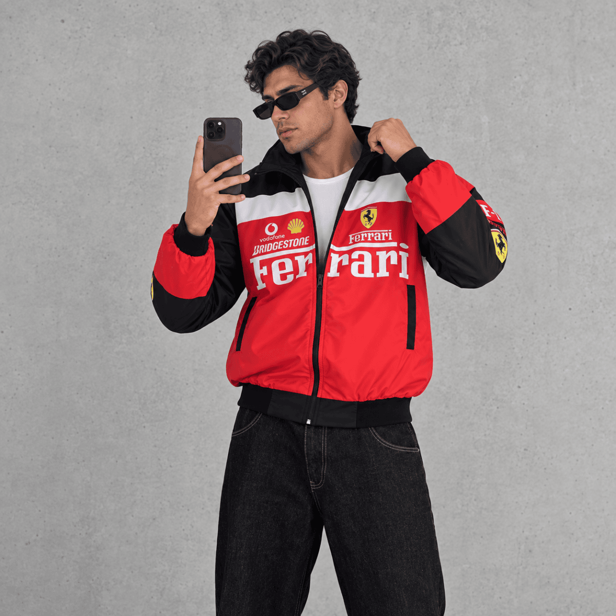 Man wearing Ferrari Formula 1 team jacket with red, black, and white colors.