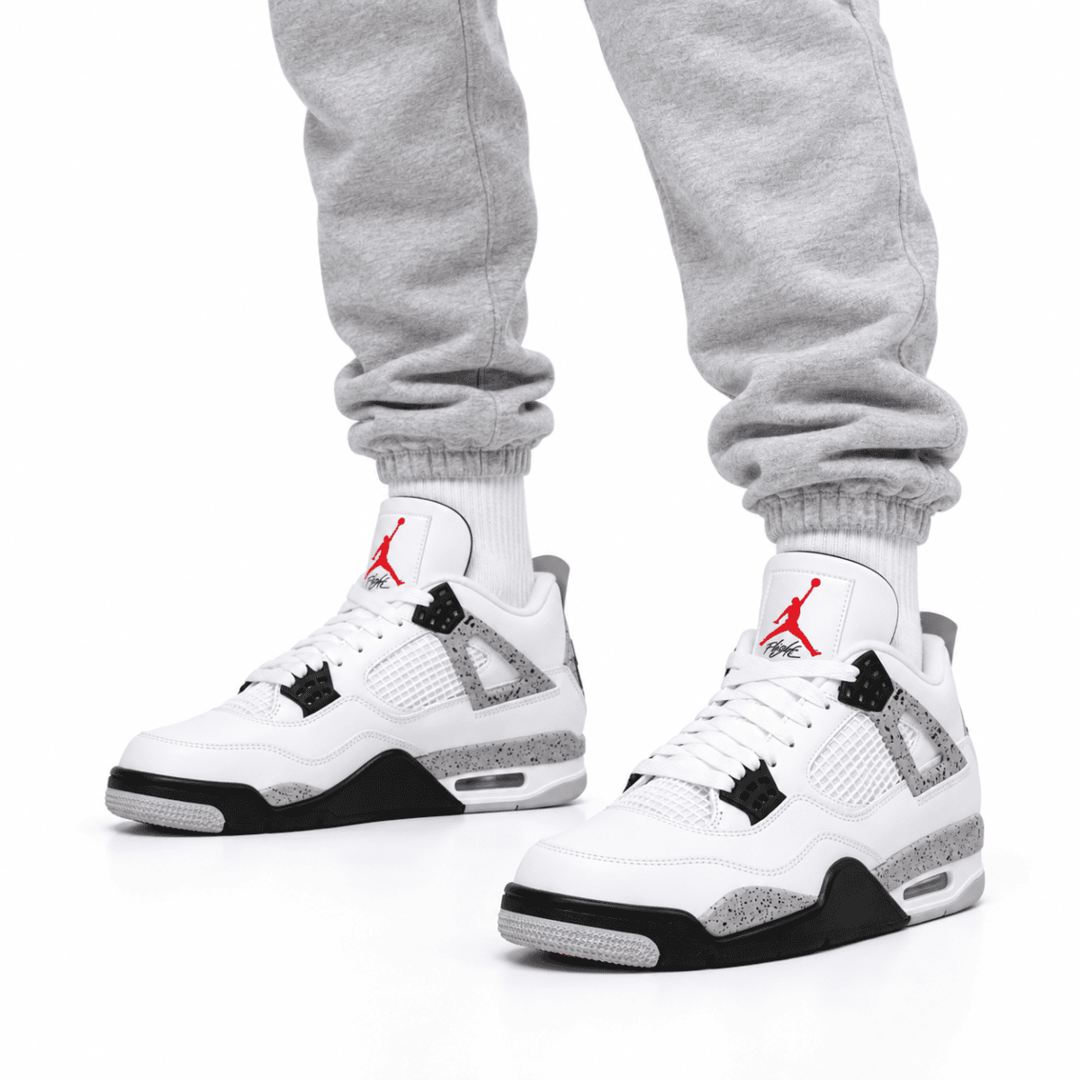 White Air Jordan 4 Retro OG sneakers with red Jumpman logo and black accents.