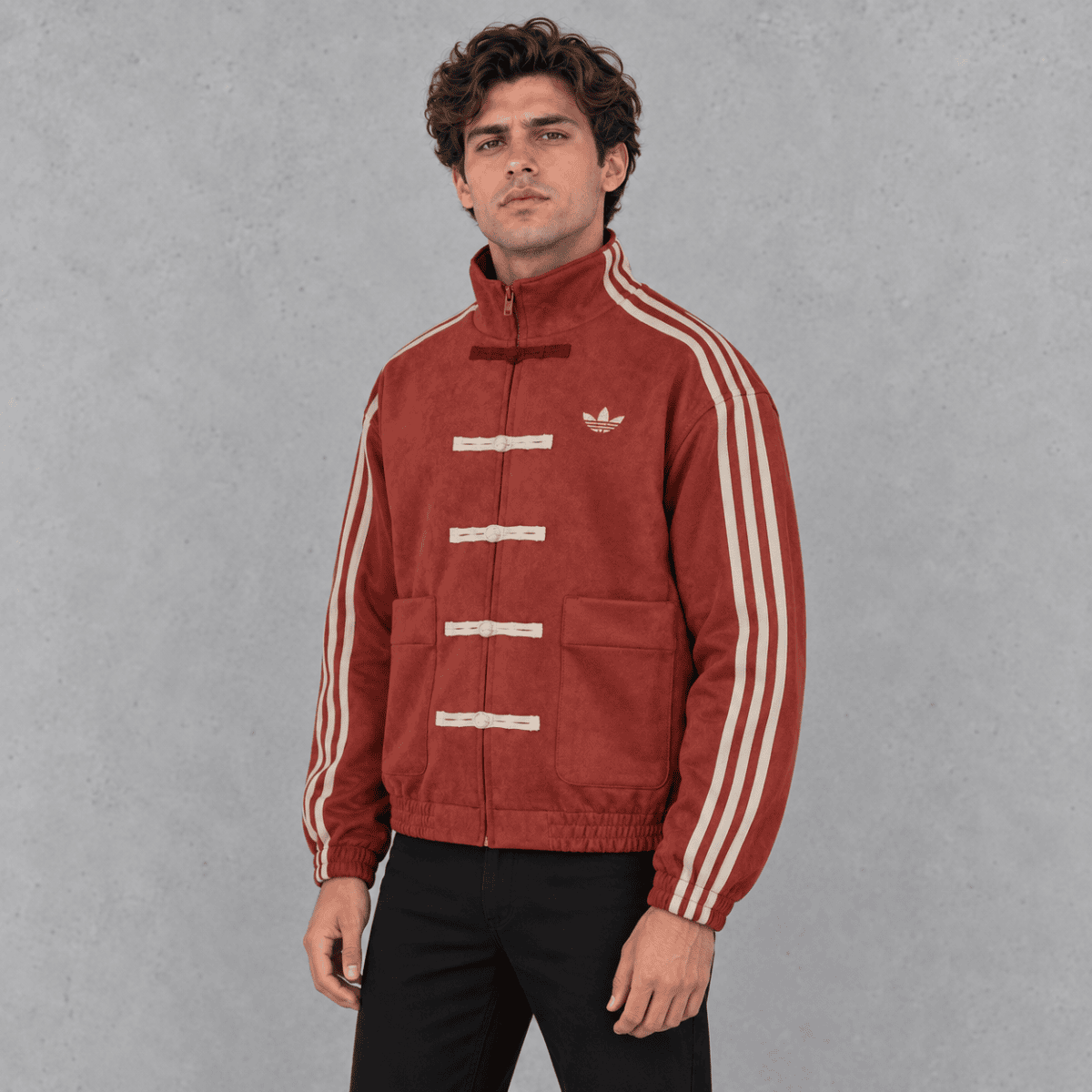 Man wearing a red vintage-style sports jacket with white stripes on sleeves.