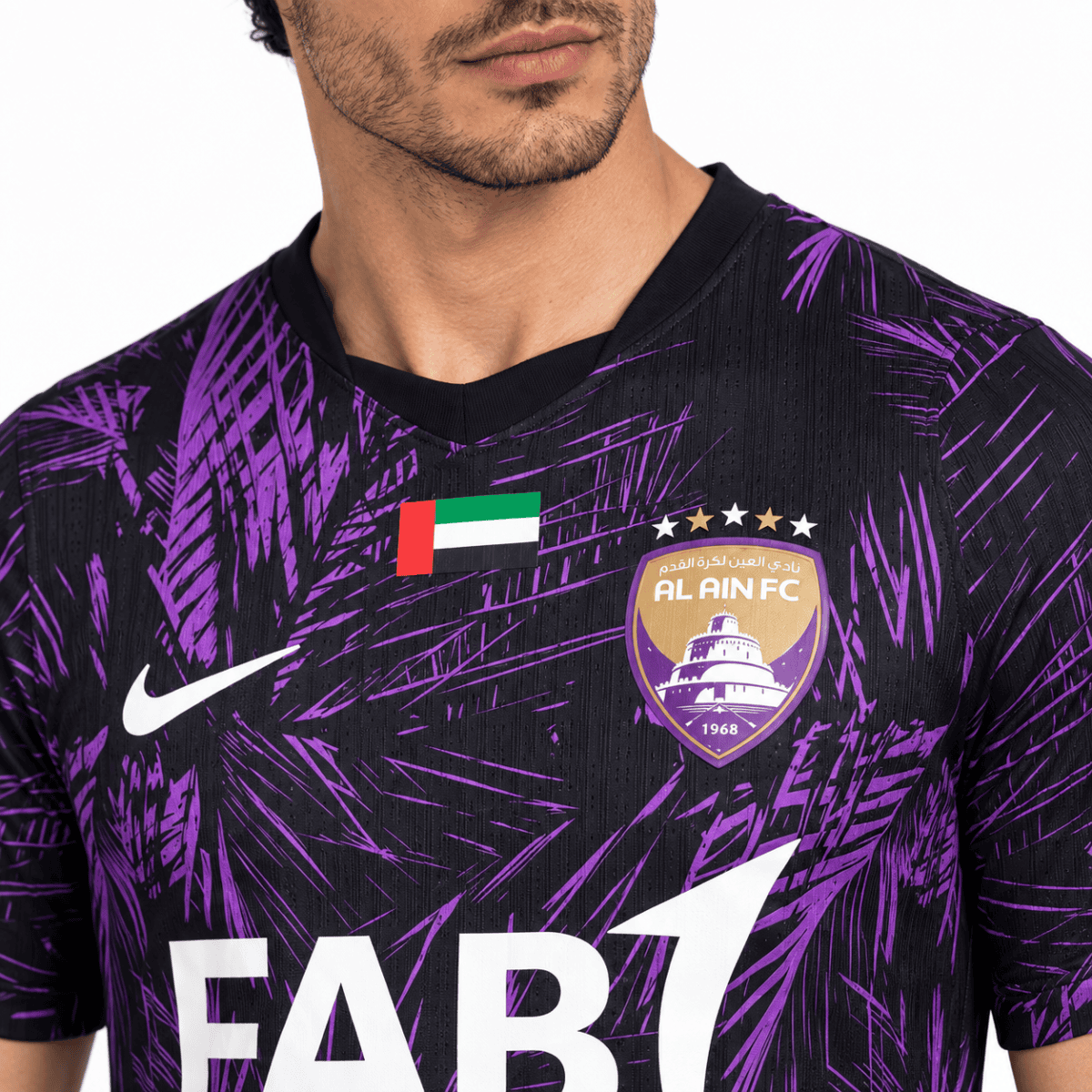 Al Ain FC football jersey with purple palm leaf pattern, club badge, Nike logo, and UAE flag.