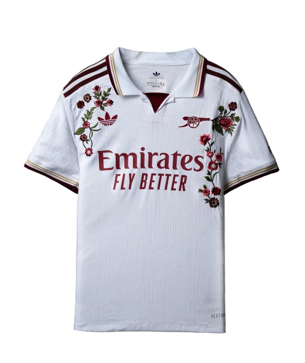 Real Madrid away football jersey with floral design and Emirates sponsor logo.