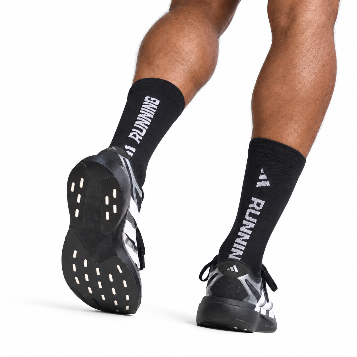 9e0a8d03-3418-405d-977f-66623ee1f3c6 - UAE SPORT STORE Running shoes with black socks, 'RUNNING' text on one sock, white and black design.