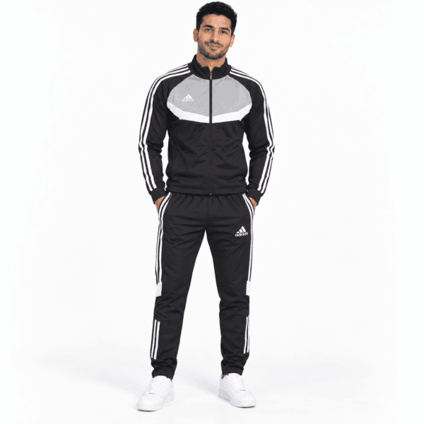 ChatGPT Image Sep 18 2026 07_07_52 PM 2 - UAE SPORT STORE Man in black and grey Adidas tracksuit with white stripes, standing against white background.