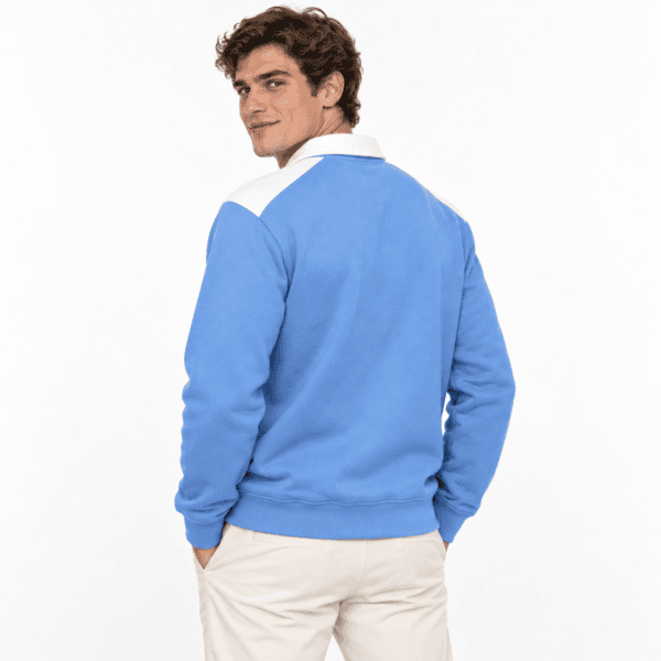 Man wearing a blue and white long-sleeve polo shirt, facing away.