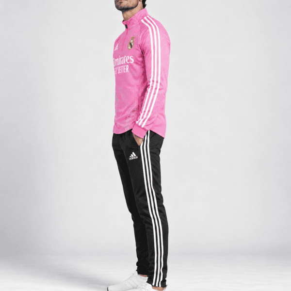 Real Madrid pink edition tracksuit 2023/24 with club crest and Adidas stripes.