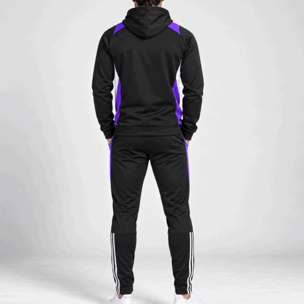 Man in black and purple sports hoodie and pants, back view.
