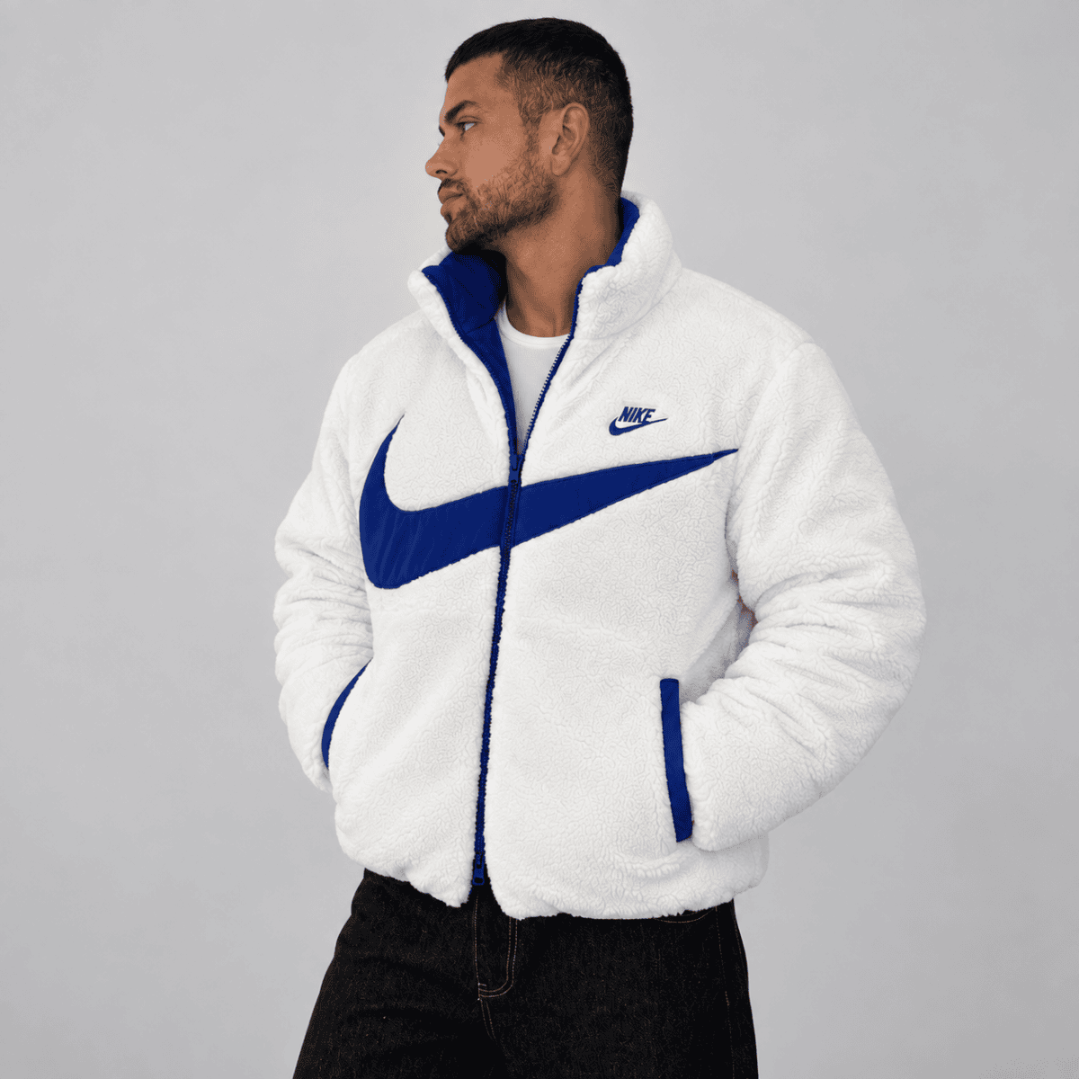 Nike white fleece jacket with blue logo and accents, front view.