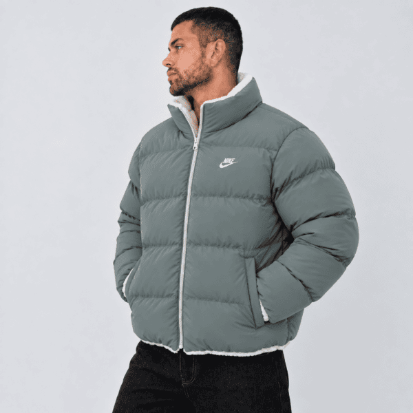 Men's Nike puffer jacket in grey with white logo and zipper, front view.