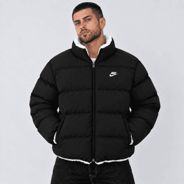 ChatGPT Image Sep 23 2026 07_27_48 PM 1 - UAE SPORT STORE Man wearing black Nike puffer jacket with white logo and lining.