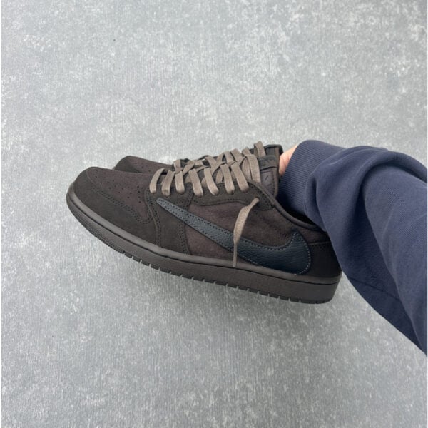 Black and dark brown Air Jordan 1 Low OG SP sneakers with beige laces.