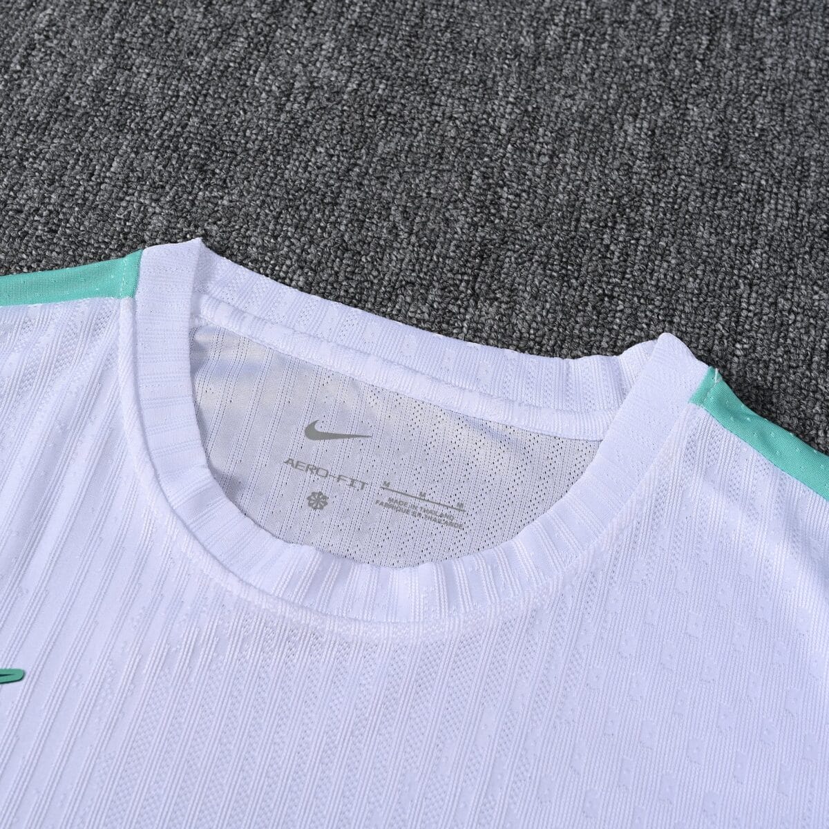 White Nike football jersey with light blue accents and club badge.