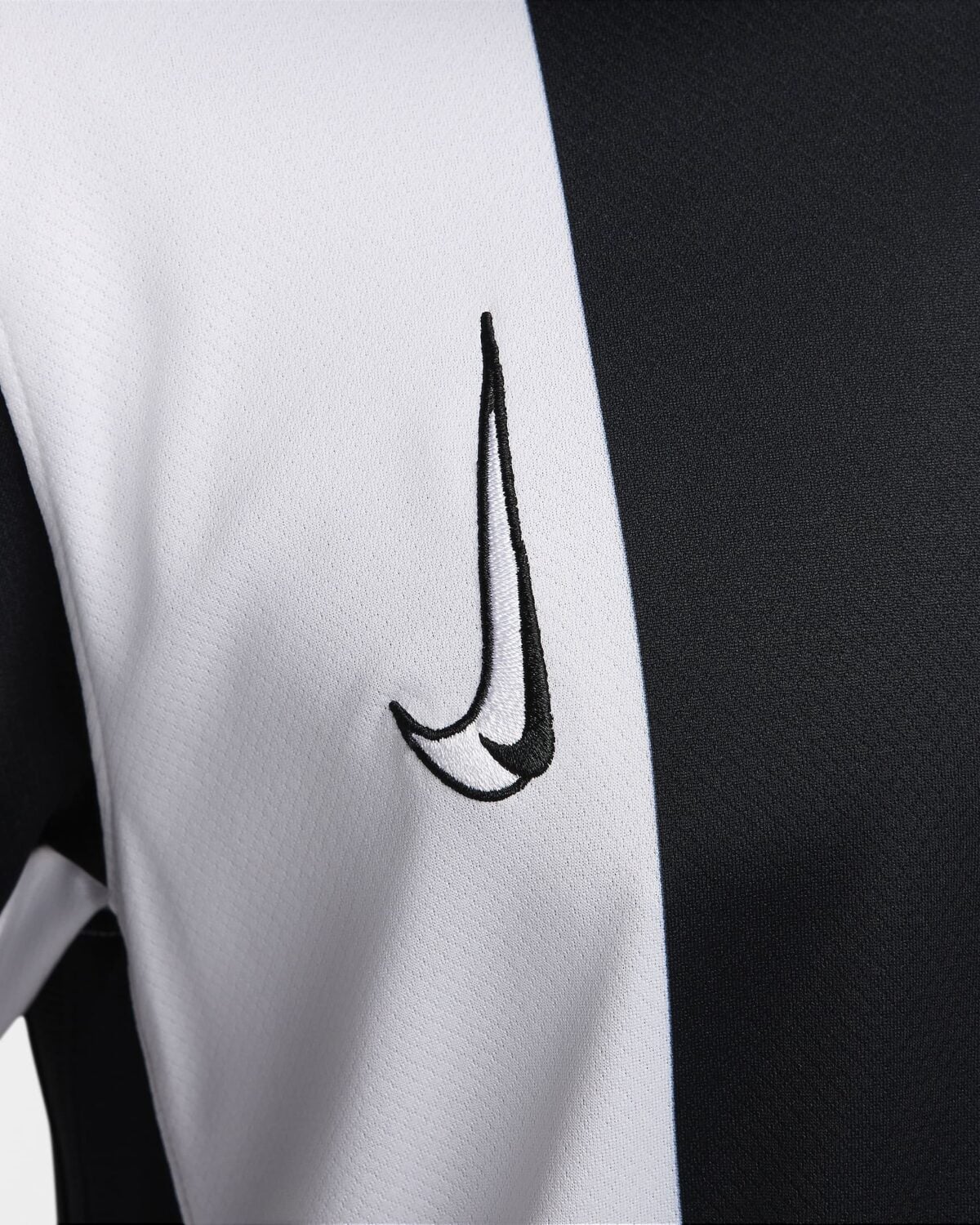 Close-up of a white and black sports jersey with Nike logo.