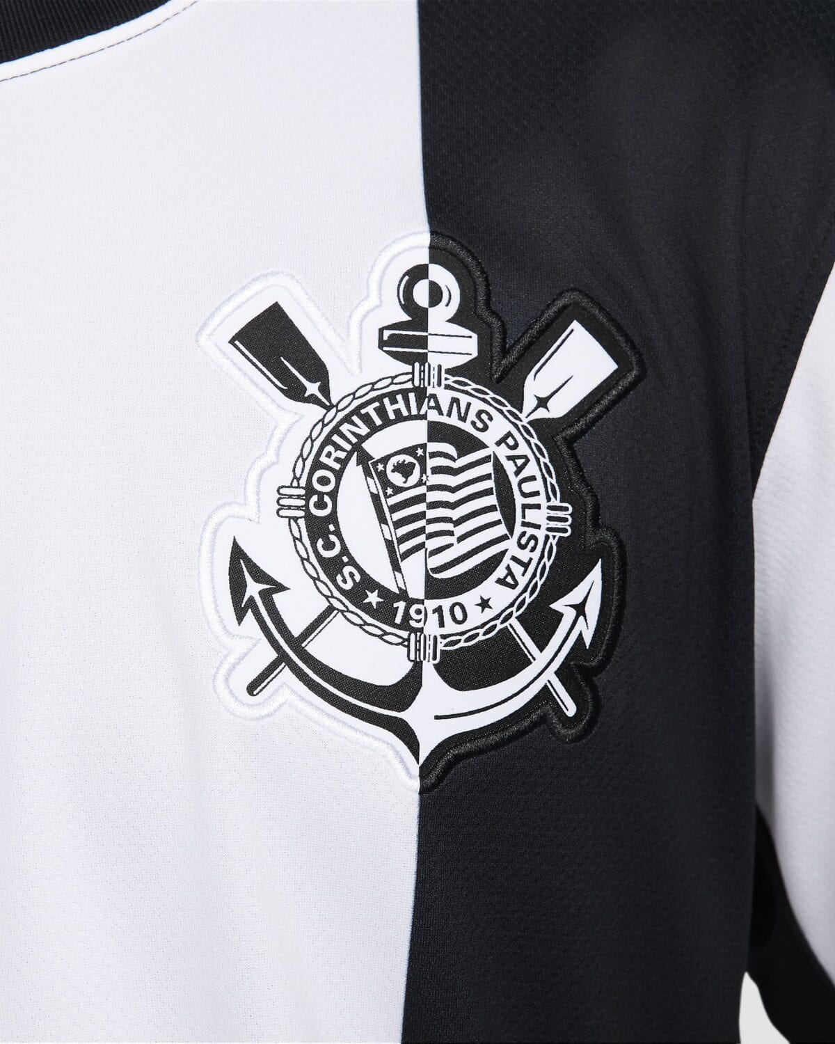 Corinthians Paulista football club logo on black and white jersey.
