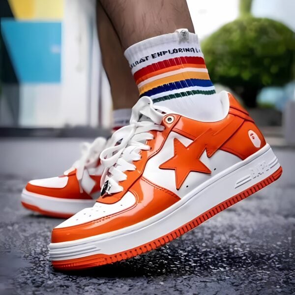 Orange and white sports shoes with rainbow socks on a wet surface.
