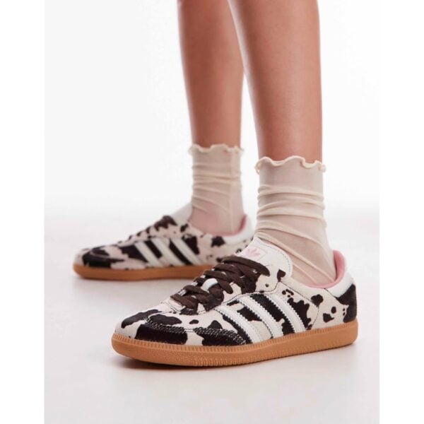 adidas Samba OG Cow Print sneakers worn front side view with gum sole - UAE SPORT STORE adidas Samba OG Cow Print sneakers worn front side view with gum sole