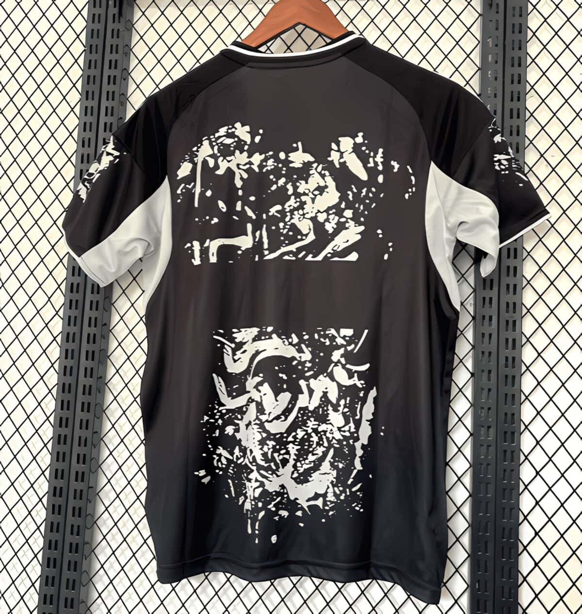 Black and white football jersey with abstract graphic design on back.