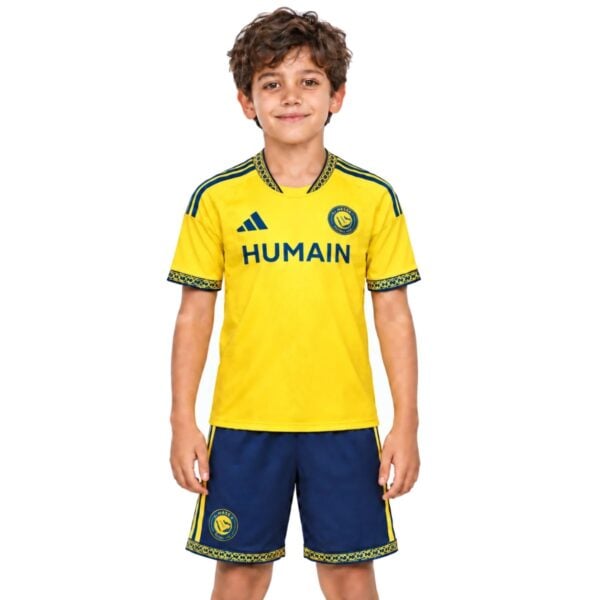 Al Nassr Home Kit Kids 2026/27 yellow jersey and navy shorts front view with HUMAIN sponsor