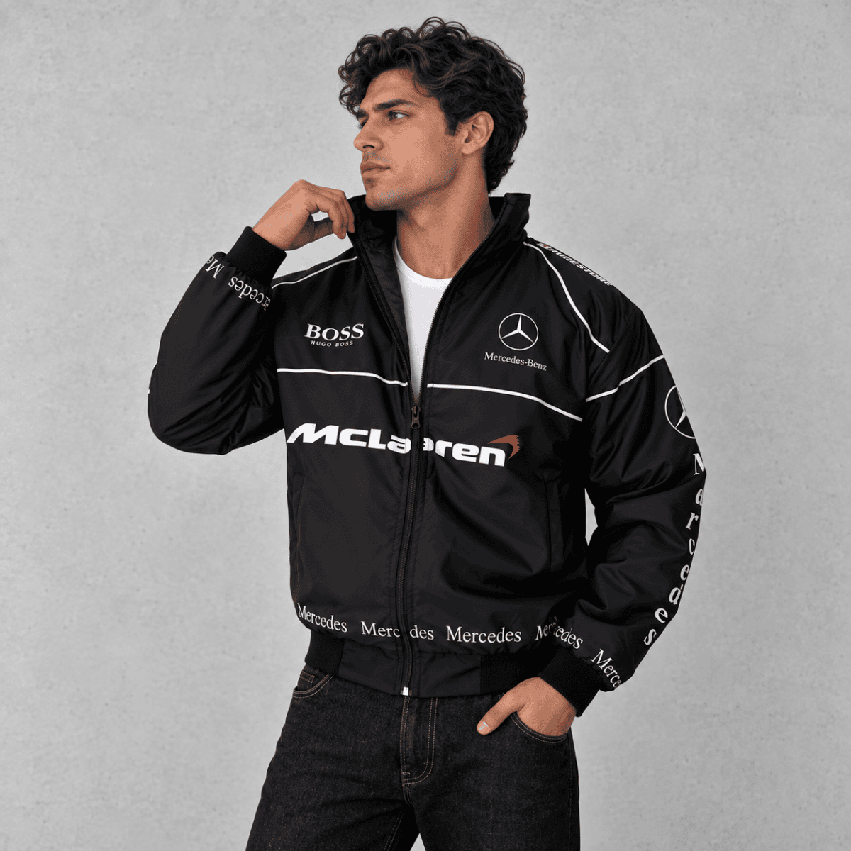 Man wearing black Mercedes-AMG Petronas Formula 1 team jacket with logos.