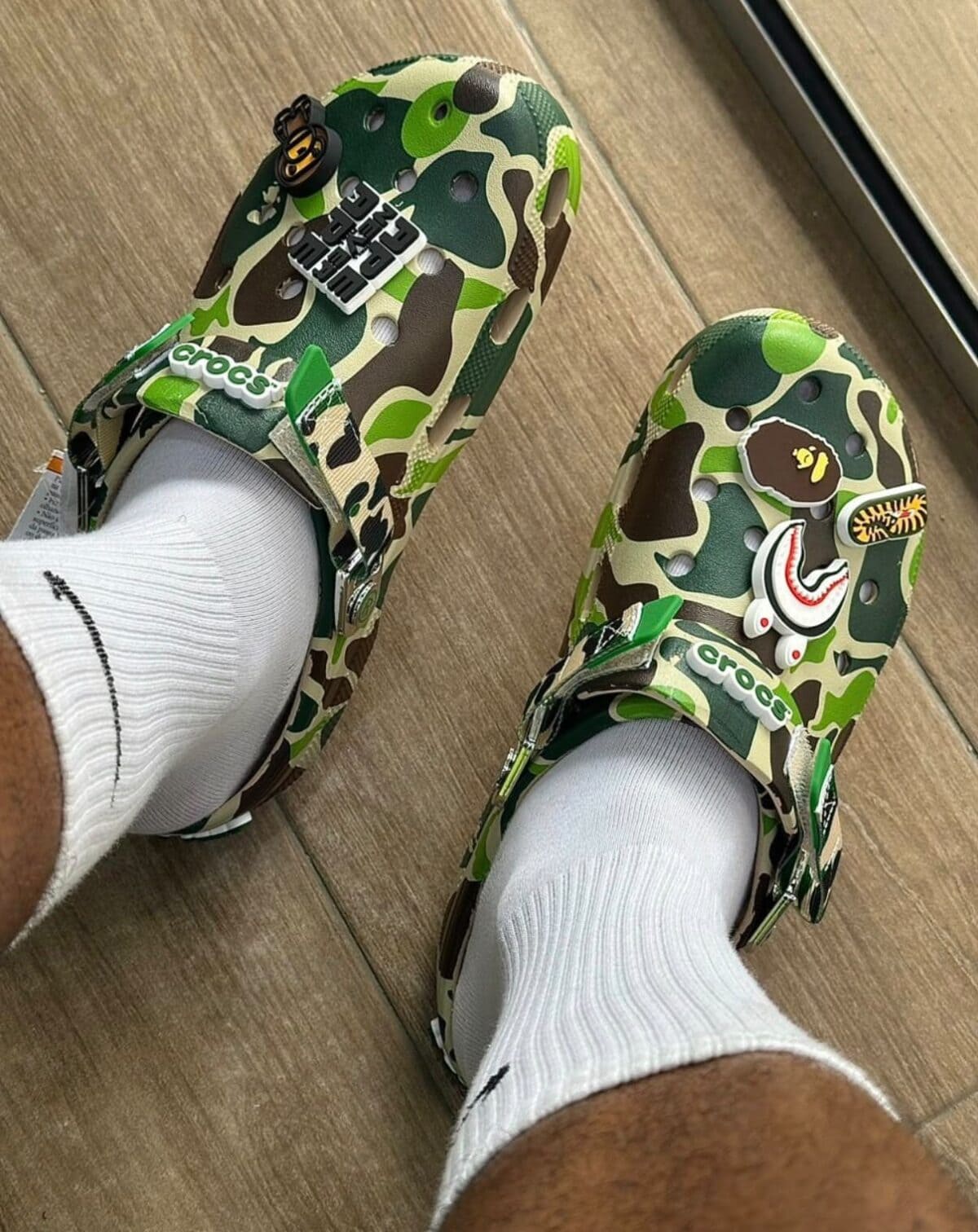 BAPE x Crocs Classic Clog in ABC Camo Green on feet with white socks.
