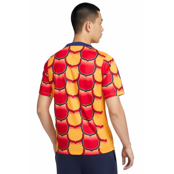 Football jersey with red, yellow, and navy blue geometric pattern for UAE national team.