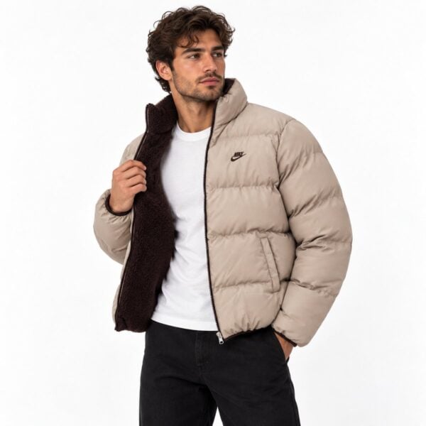 beige-open - UAE SPORT STORE Man wearing beige Nike puffer jacket with black interior and white T-shirt.