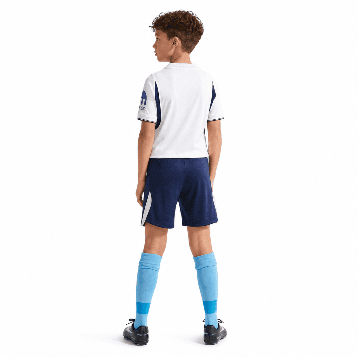 Child wearing Tottenham Kids Home Kit 2026/27, white and navy blue jersey and shorts.