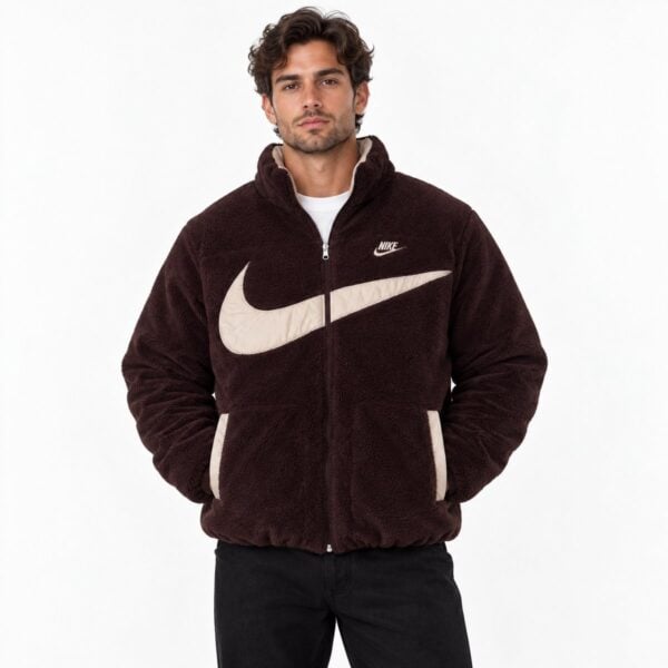 Man wearing a brown Nike fleece jacket with large beige Nike swoosh logo.