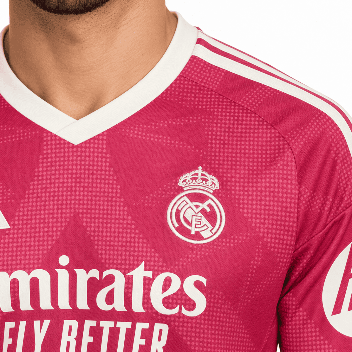 Real Madrid away kit jersey with crest and sponsor logo in pink and white.