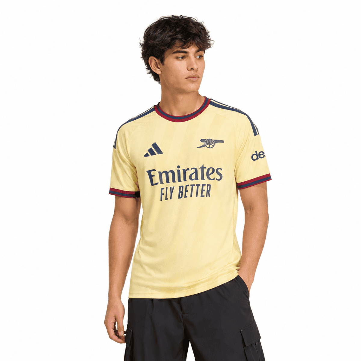 Arsenal third jersey 2026/27, yellow with navy and red accents, club badge visible.