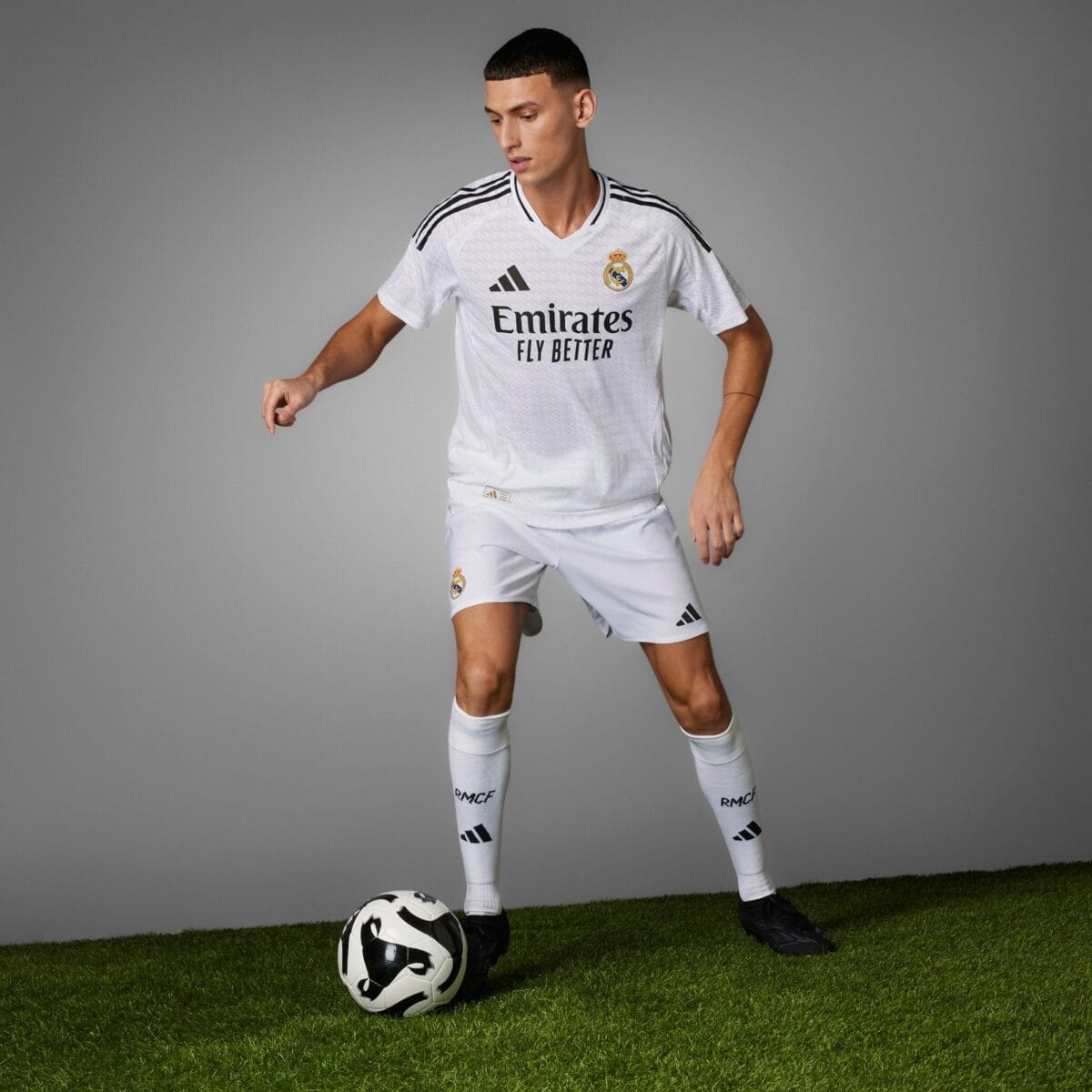 Real Madrid away kit 2023-24, white jersey and shorts, with black accents.