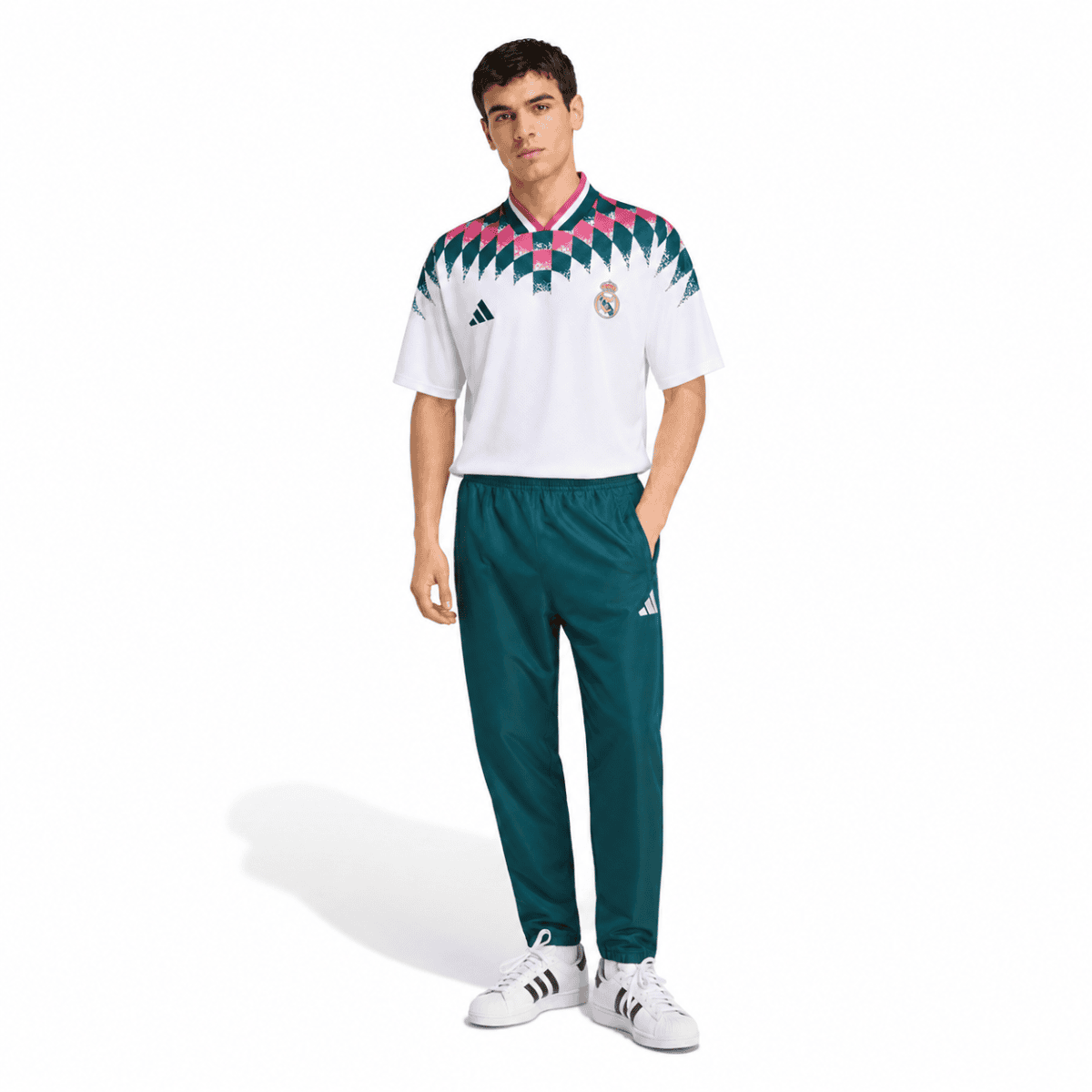 Real Madrid lifestyle jersey with geometric pattern and teal pants on male model.