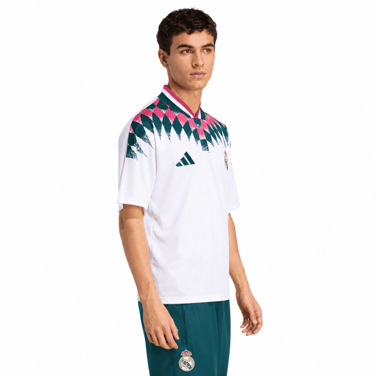 Real Madrid lifestyle jersey with white base and pink, green, and black pattern on shoulders.