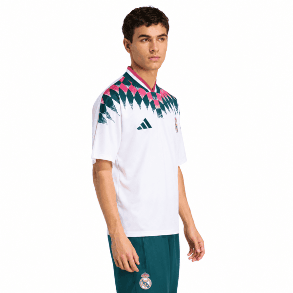 db0def22-ee0b-4db6-a33d-8c3052dd693f - UAE SPORT STORE Real Madrid lifestyle jersey with white base and pink, green, and black pattern on shoulders.