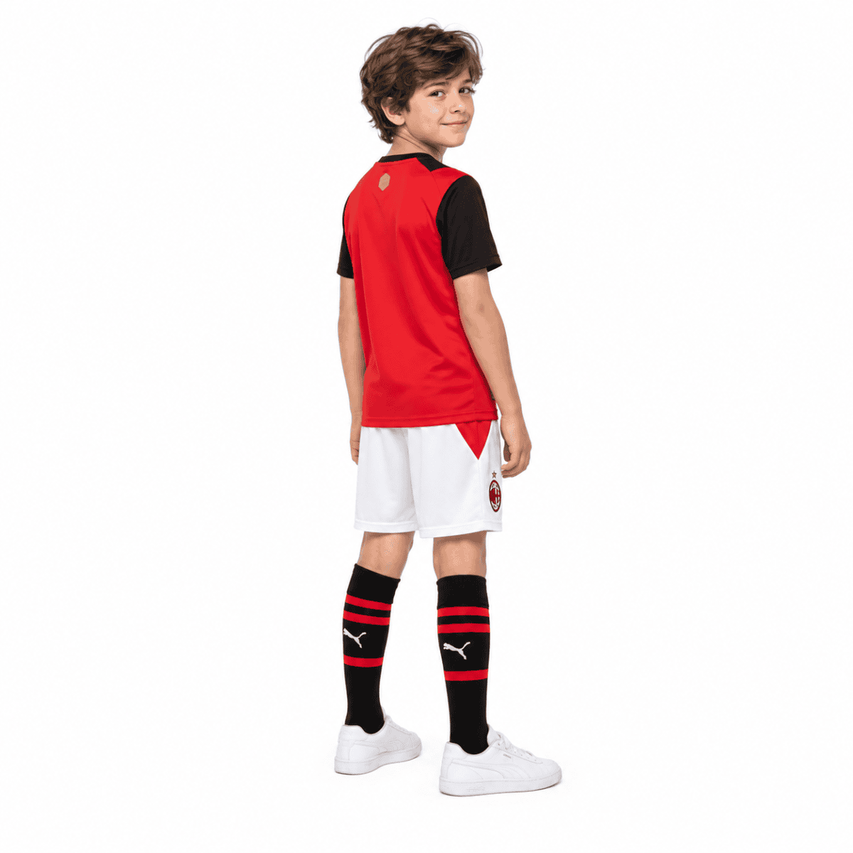 Kids AC Milan home kit 2026/27 with red and black jersey, white shorts, and black socks.