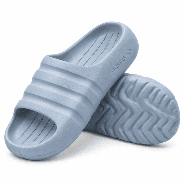 e0b112b9-11b7-4107-bb1e-9b98aba7e842 - UAE SPORT STORE Light blue Adidas Adilette Ayoon Slides with three stripes and textured sole.