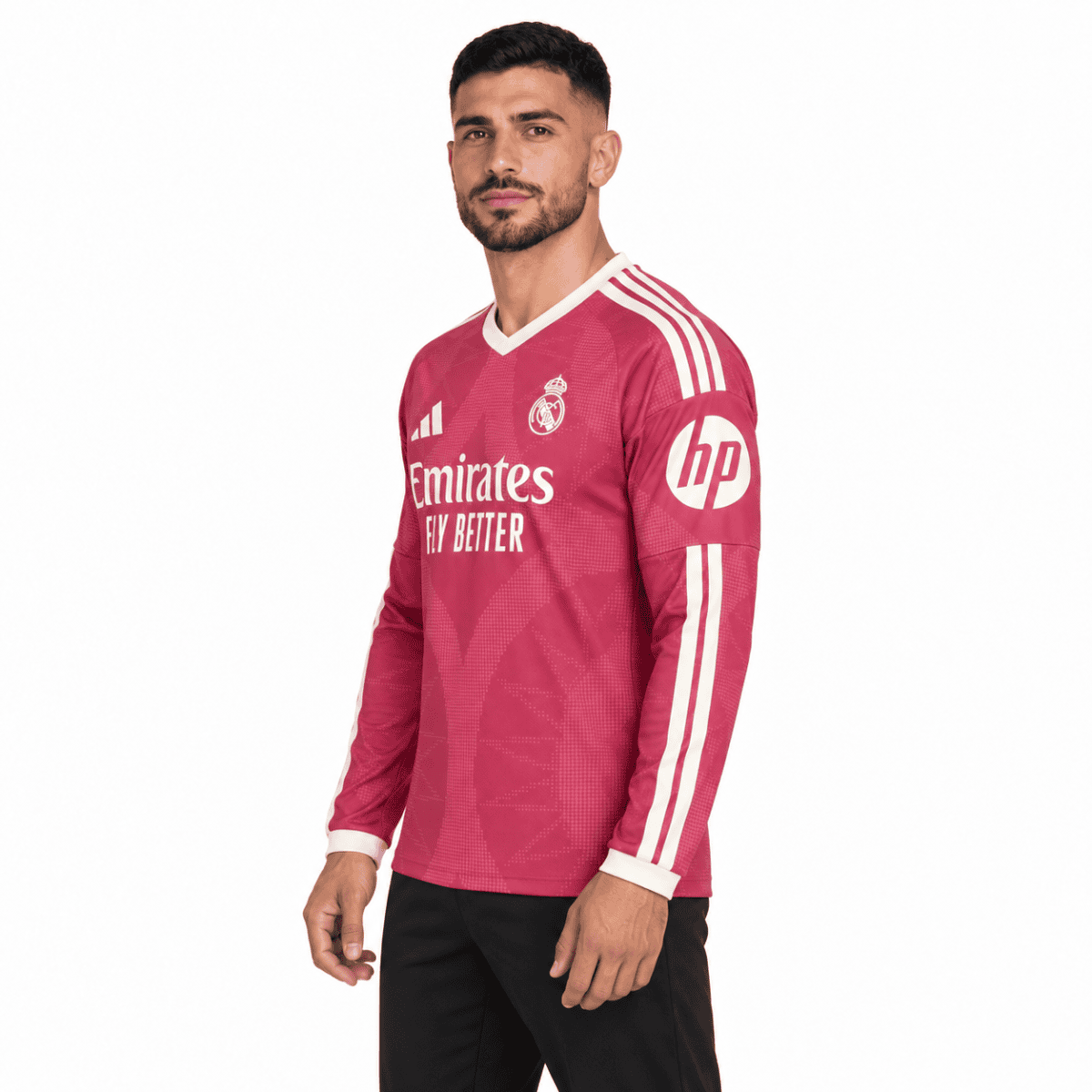 Real Madrid away football jersey pink with white stripes and sponsor logos.