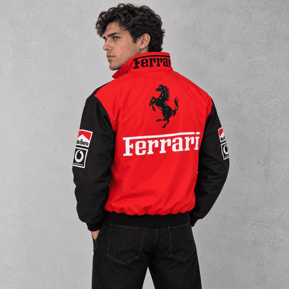 Red and black Ferrari Formula 1 team jacket with logo and sponsor patches.