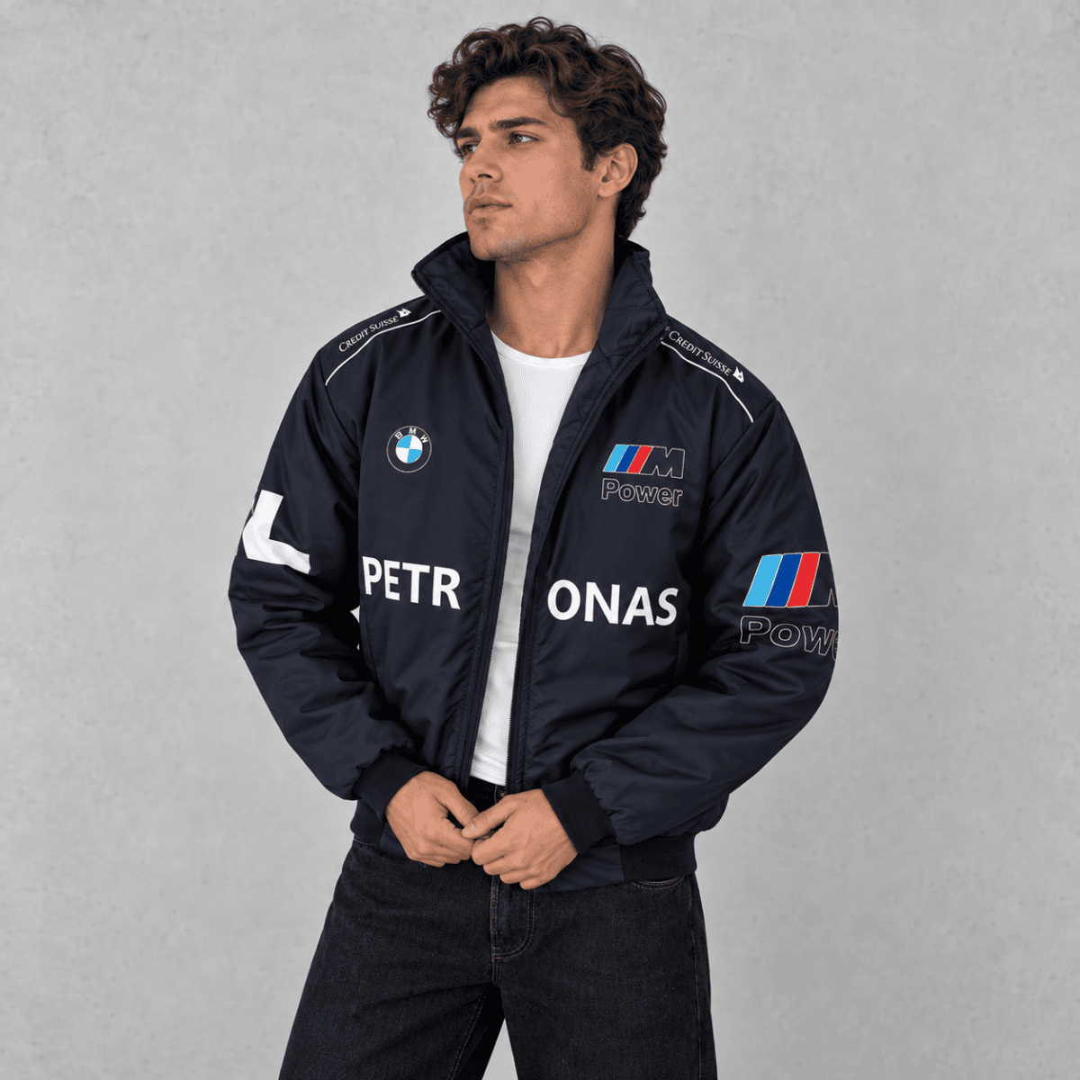 Man wearing BMW M Power racing jacket with logos and text.